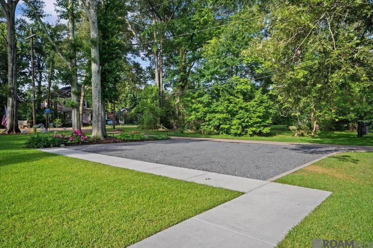 Tree-lined approach and driveway at 6411 Goodwood Avenue